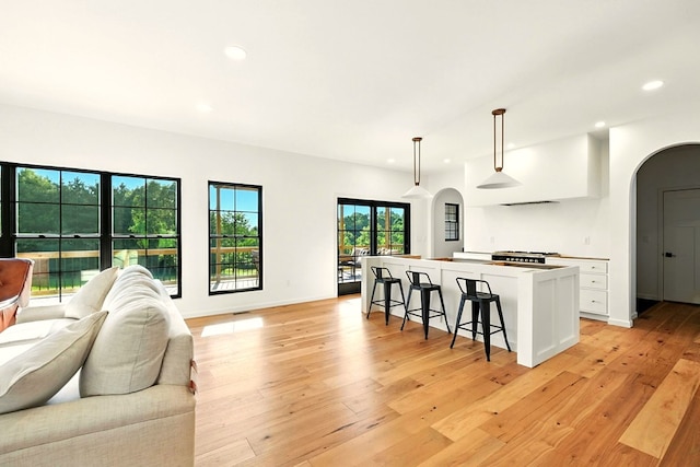 1360 Lexington Ontario Rd, Mansfield, OH 44904 - kitchen featuring arched walkways, open floor plan, white cabinetry, a center island, and recessed lighting