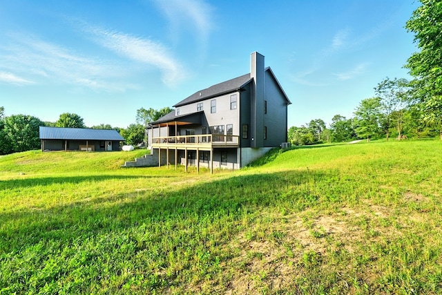 1360 Lexington Ontario Rd, Mansfield, OH 44904 - back of house featuring a wooden deck, a chimney, and a lawn