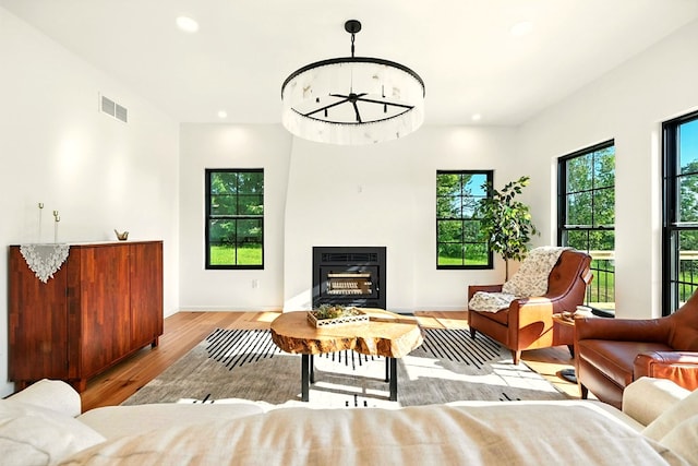 1360 Lexington Ontario Rd, Mansfield, OH 44904 - living area with wood finished floors, recessed lighting, a glass covered fireplace, and heating unit