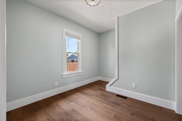 519 Park Ave, Galion, OH 44833 - unfurnished room featuring dark wood-style flooring and a textured ceiling