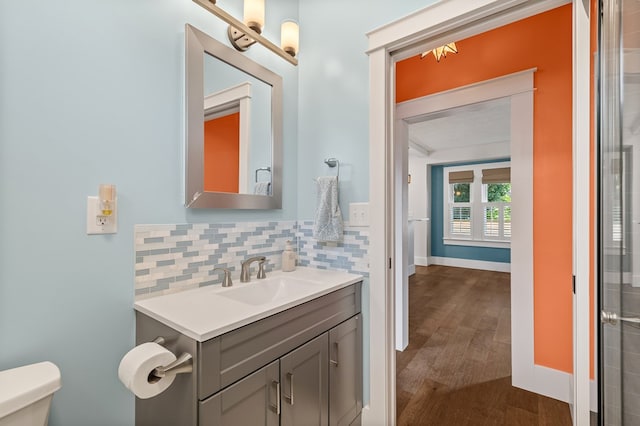 519 Park Ave, Galion, OH 44833 - bathroom with vanity, wood finished floors, and decorative backsplash