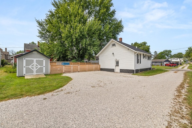 519 Park Ave, Galion, OH 44833 - view of side of property with a storage shed, a chimney, and driveway