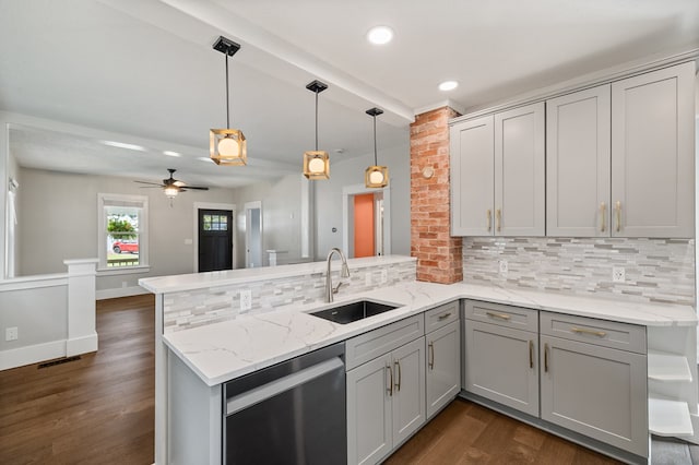 519 Park Ave, Galion, OH 44833 - kitchen featuring dishwasher, a peninsula, gray cabinetry, dark wood-style flooring, and backsplash