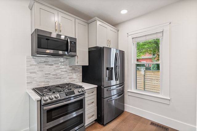 519 Park Ave, Galion, OH 44833 - kitchen with appliances with stainless steel finishes, backsplash, light wood-style floors, and recessed lighting