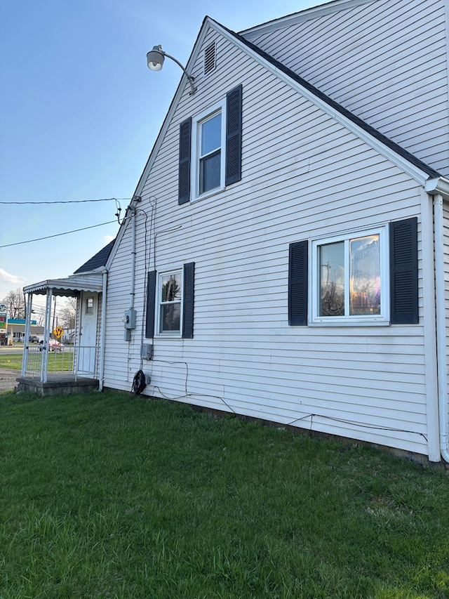 view of home's exterior with a yard