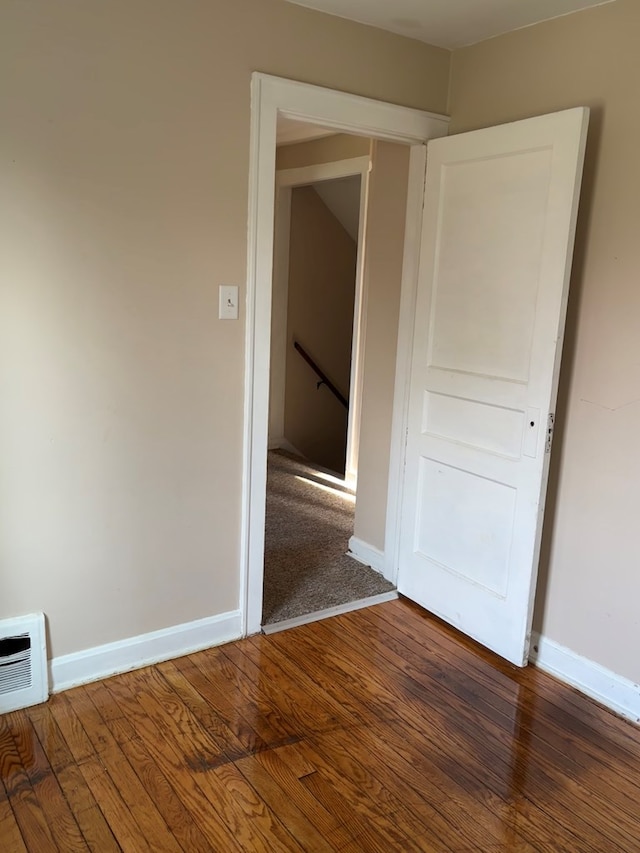 unfurnished room featuring baseboards and wood finished floors