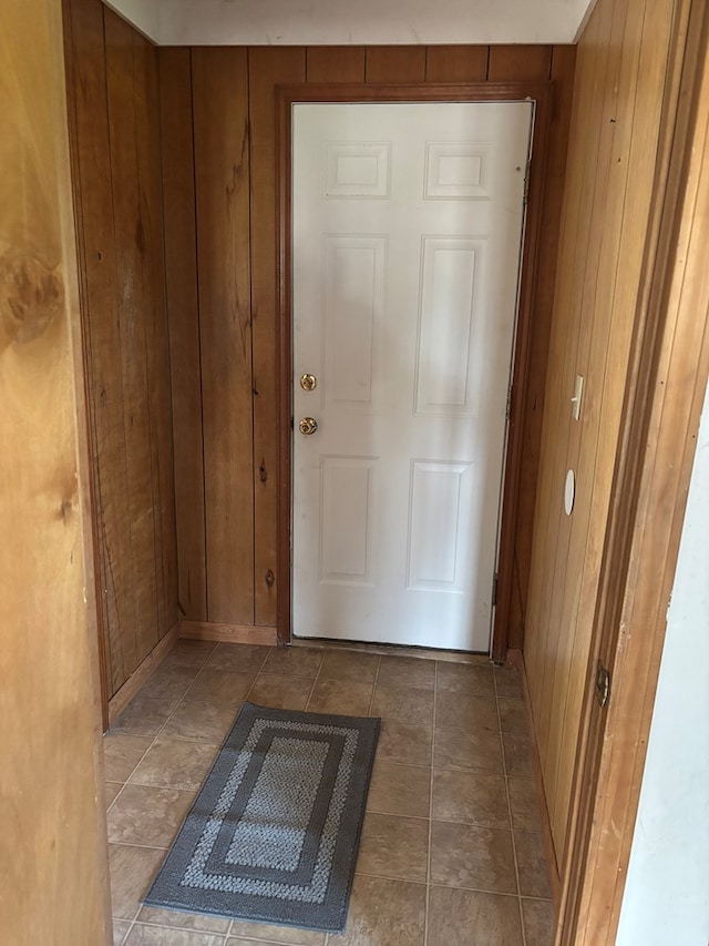 doorway to outside featuring wooden walls