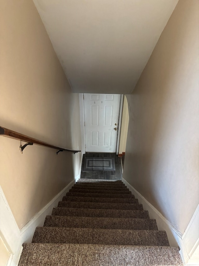 stairway featuring baseboards