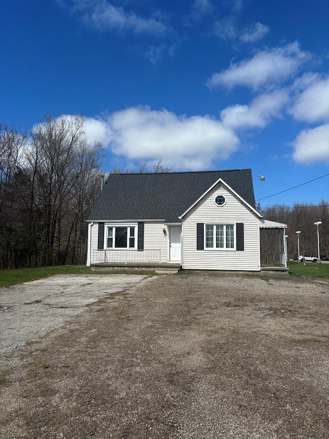 ranch-style house featuring driveway and a shingled roof