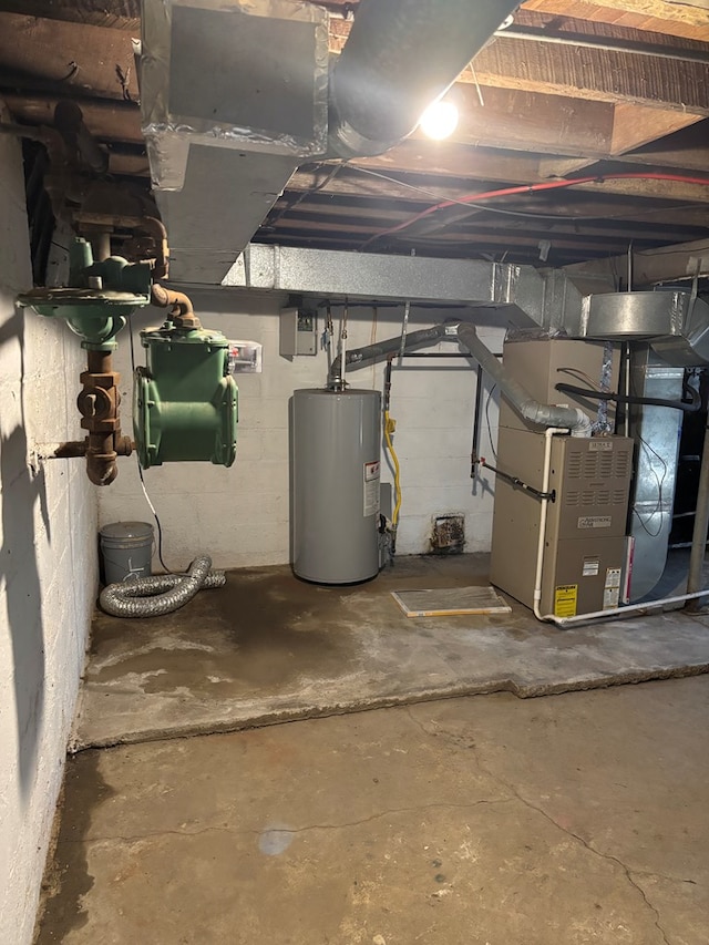 unfinished basement featuring water heater, heating unit, and concrete block wall