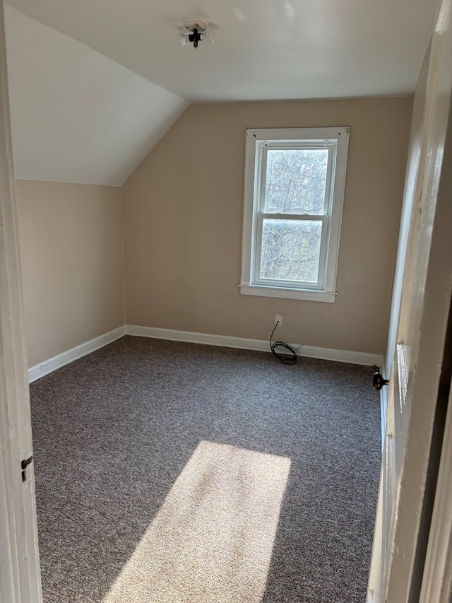 bonus room with lofted ceiling, carpet floors, and baseboards