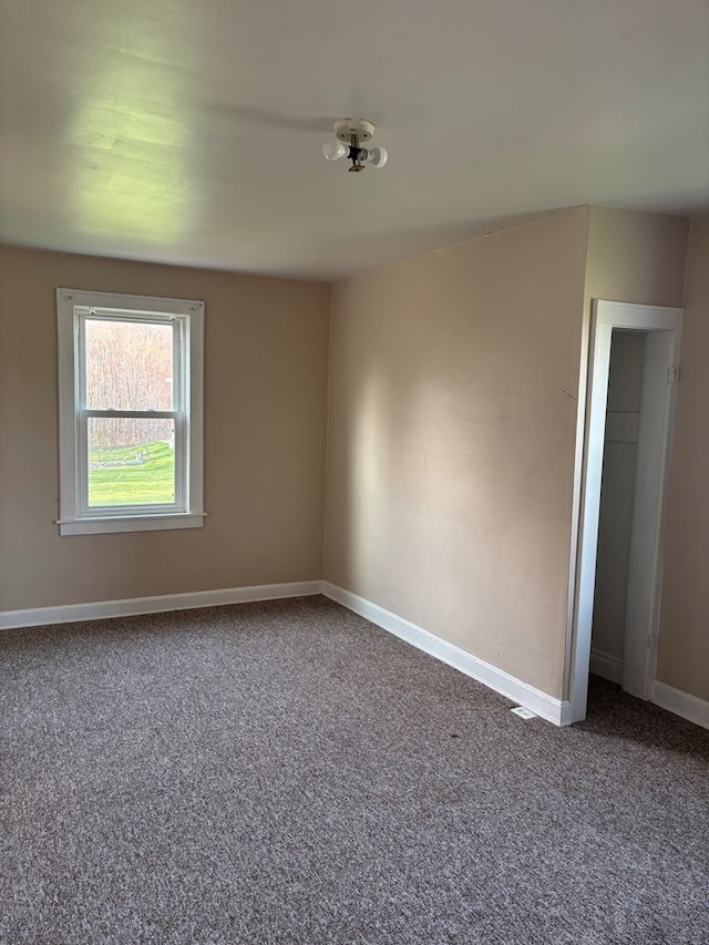 spare room with carpet floors and baseboards