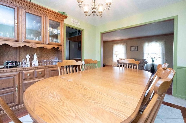 452 Pleasant Ln, Bucyrus, OH 44820 - dining space featuring a chandelier, visible vents, and light tile patterned flooring