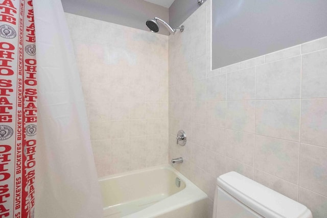 452 Pleasant Ln, Bucyrus, OH 44820 - bathroom featuring tile walls, toilet, and shower / bath combination with curtain