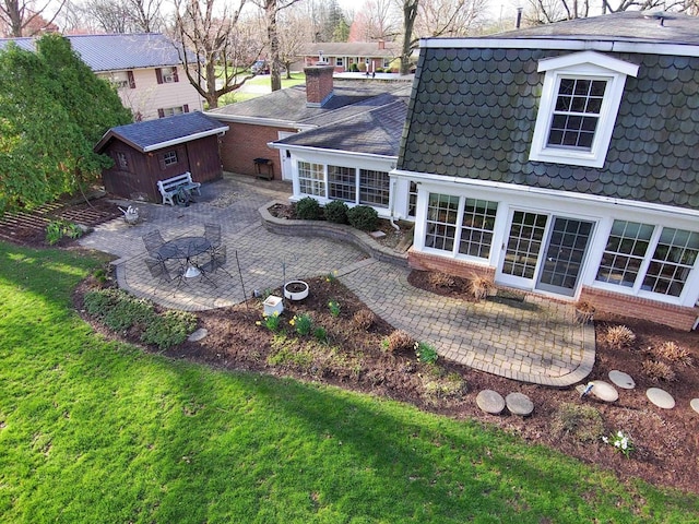 452 Pleasant Ln, Bucyrus, OH 44820 - back of property featuring a lawn, a shed, an outbuilding, and a patio