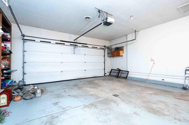 452 Pleasant Ln, Bucyrus, OH 44820 - garage featuring visible vents and a garage door opener