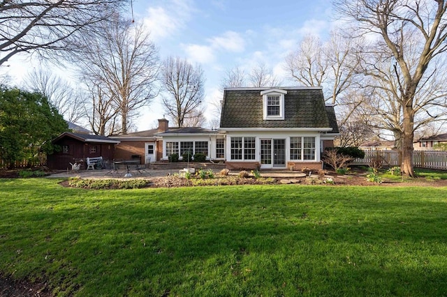 452 Pleasant Ln, Bucyrus, OH 44820 - back of property with a lawn, fence, a patio area, and mansard roof