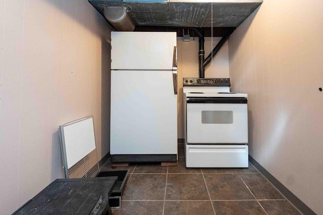 452 Pleasant Ln, Bucyrus, OH 44820 - kitchen featuring baseboards, dark tile patterned flooring, and white appliances