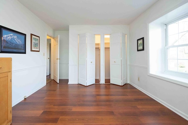 452 Pleasant Ln, Bucyrus, OH 44820 - unfurnished bedroom featuring baseboards, dark wood-style floors, and multiple windows