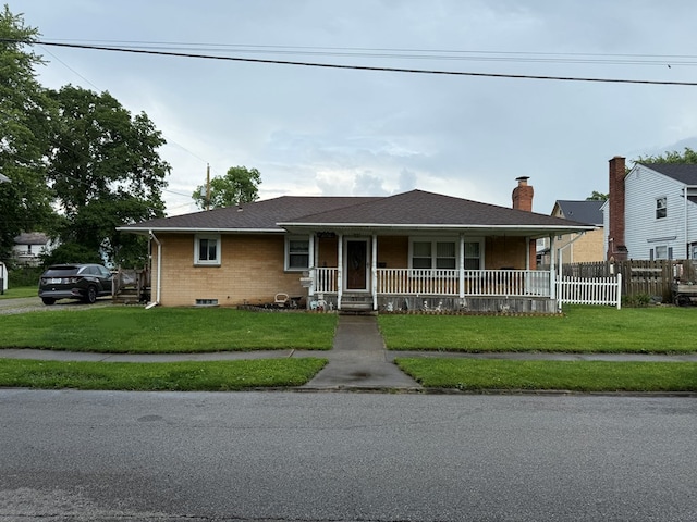 1022 S E E, Bucyrus, OH 44820 - view of front facade with covered porch, brick siding, and a chimney