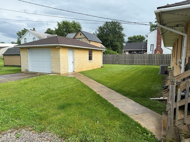 1022 S E E, Bucyrus, OH 44820 - view of yard with asphalt driveway, a detached garage, and an outdoor structure