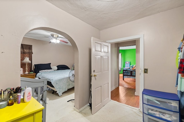 bedroom with ceiling fan and light colored carpet