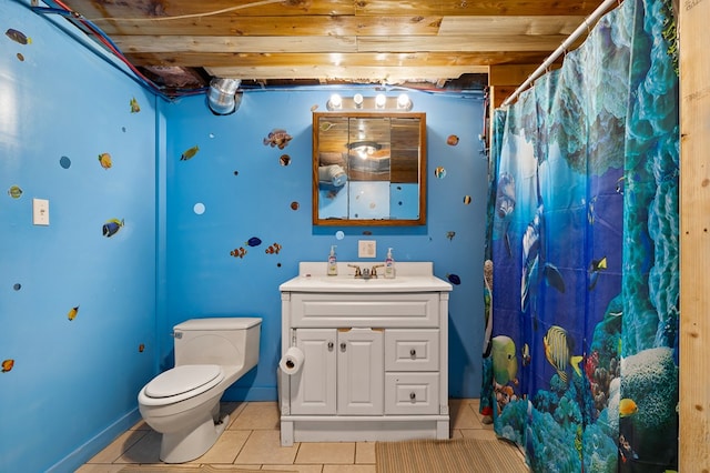 bathroom featuring toilet, a shower with curtain, vanity, and tile patterned floors