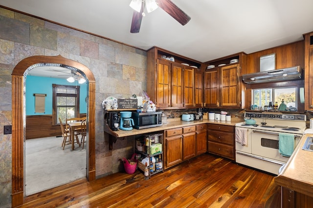 kitchen featuring white range with electric cooktop, exhaust hood, and dark hardwood / wood-style floors