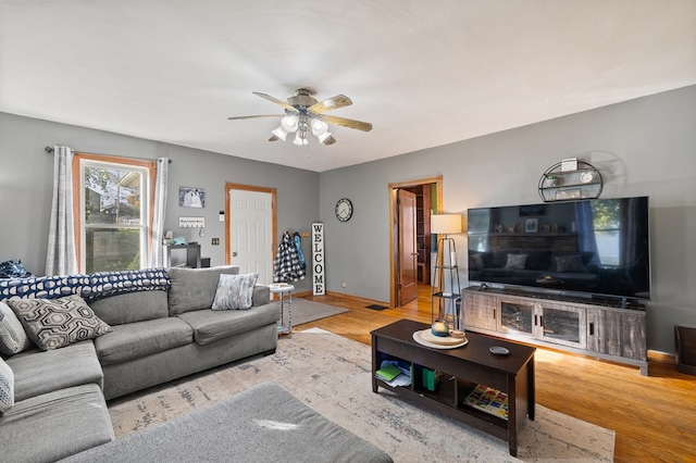 living room featuring ceiling fan and light wood-type flooring