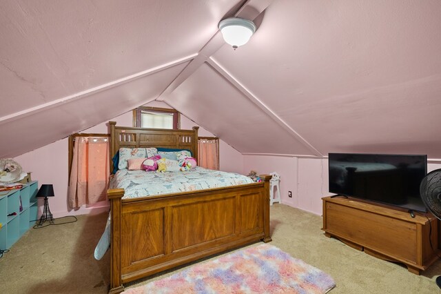 carpeted bedroom with vaulted ceiling