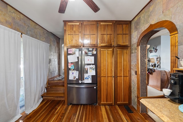 kitchen featuring dark hardwood / wood-style floors, stainless steel refrigerator, and ceiling fan