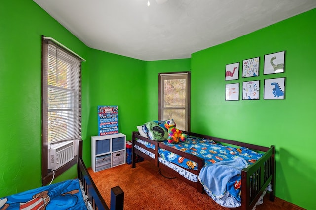 bedroom with cooling unit and carpet floors