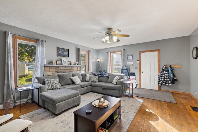 living room with ceiling fan and light wood-type flooring