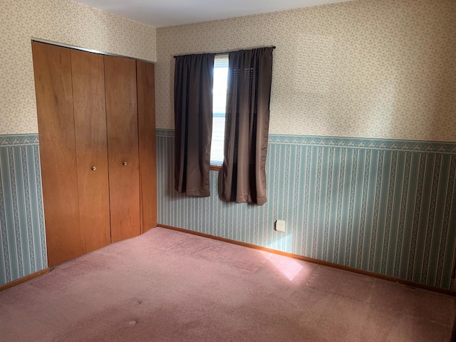 1149 Robinhood Dr, Bucyrus, OH 44820 - unfurnished bedroom featuring a closet, wallpapered walls, and carpet floors