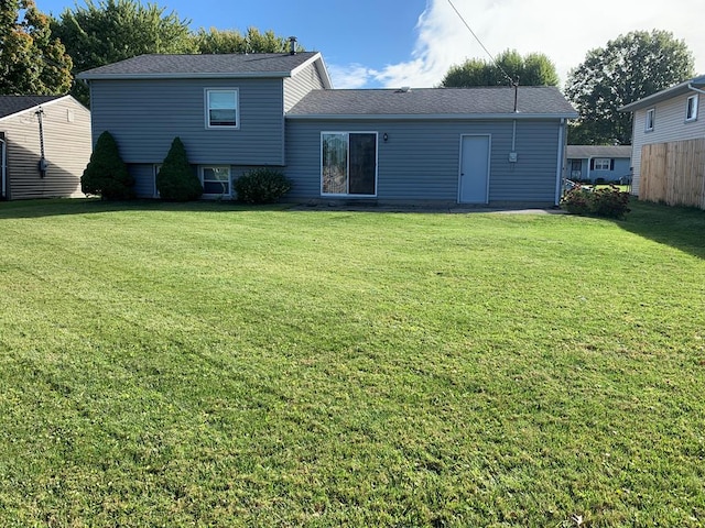 back of house with a lawn