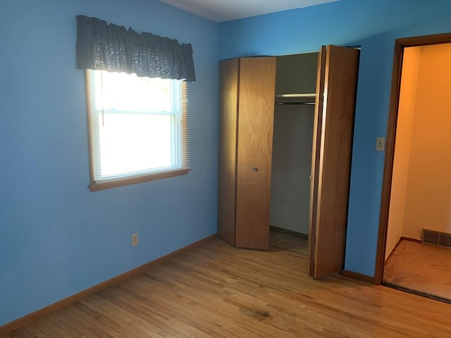 1149 Robinhood Dr, Bucyrus, OH 44820 - unfurnished bedroom featuring wood finished floors and a closet