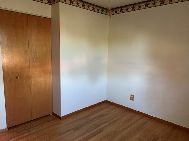 1149 Robinhood Dr, Bucyrus, OH 44820 - unfurnished bedroom with a closet and wood finished floors