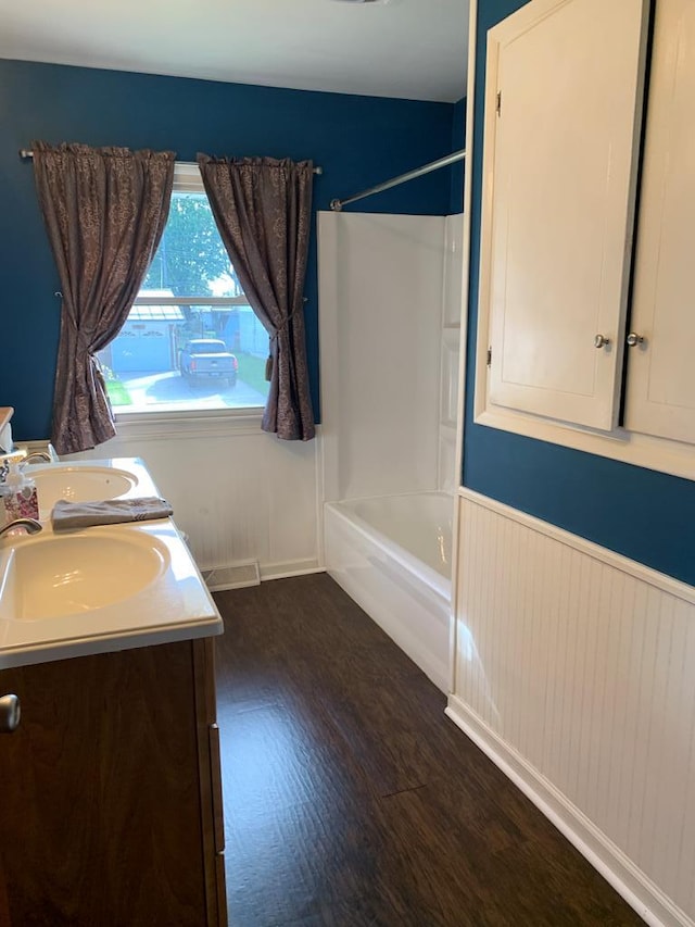 1149 Robinhood Dr, Bucyrus, OH 44820 - bathroom with bathtub / shower combination, double vanity, and wood finished floors