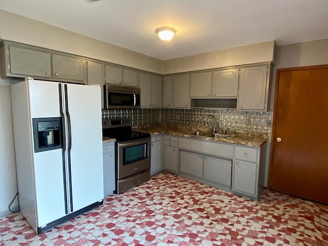 1149 Robinhood Dr, Bucyrus, OH 44820 - kitchen with stainless steel appliances, gray cabinetry, light floors, and backsplash