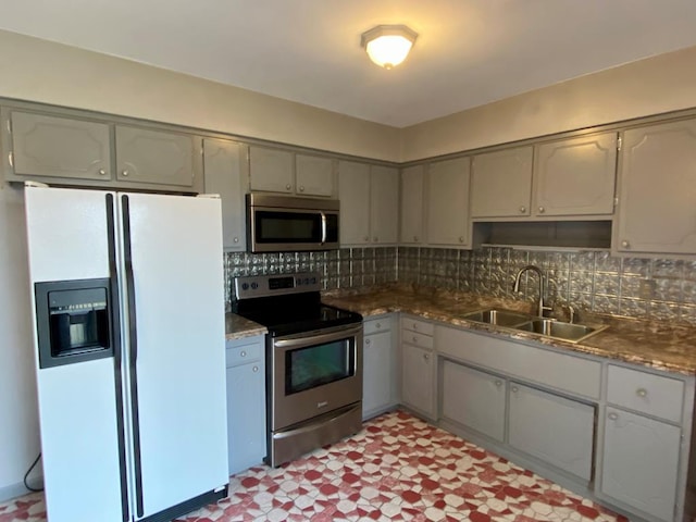 1149 Robinhood Dr, Bucyrus, OH 44820 - kitchen featuring stainless steel appliances, gray cabinetry, tasteful backsplash, light floors, and dark countertops