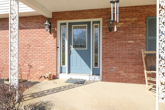 view of exterior entry with brick siding