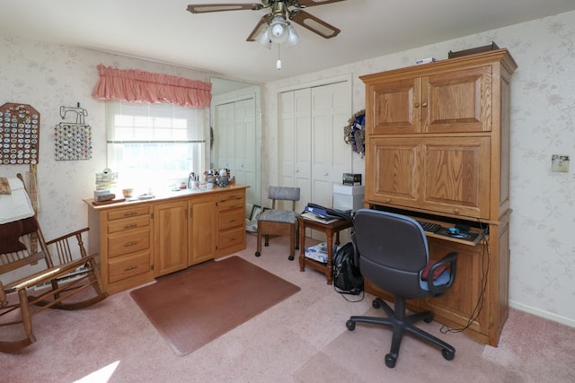 office featuring wallpapered walls, light colored carpet, baseboards, and ceiling fan