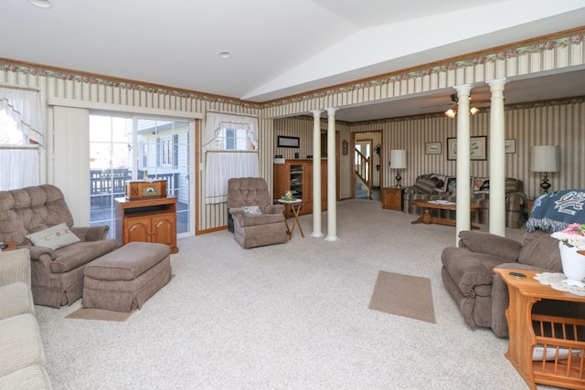 carpeted living area featuring vaulted ceiling and decorative columns