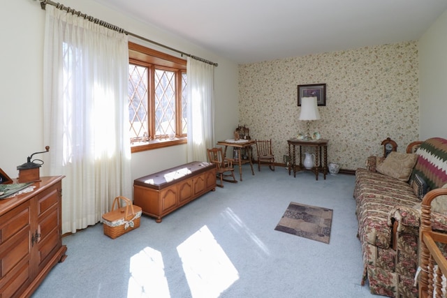sitting room with light carpet and wallpapered walls