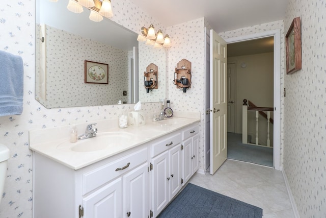 full bath with a sink and wallpapered walls
