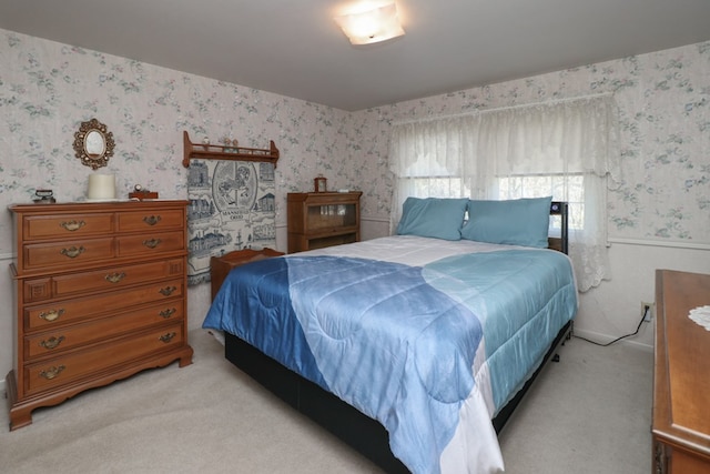bedroom with light carpet and wallpapered walls