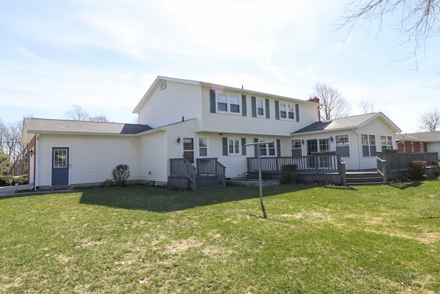 rear view of property with a lawn and a wooden deck