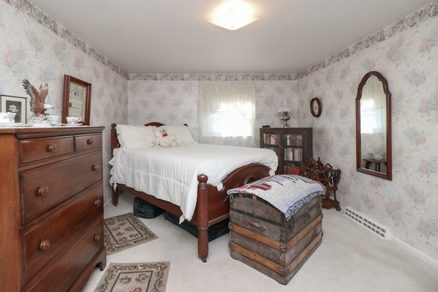 bedroom featuring light carpet, visible vents, and wallpapered walls
