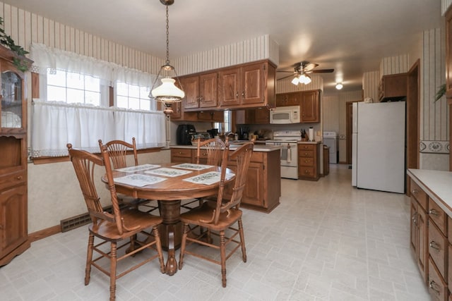 dining room with wallpapered walls and ceiling fan