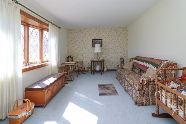 living area with wallpapered walls and light colored carpet